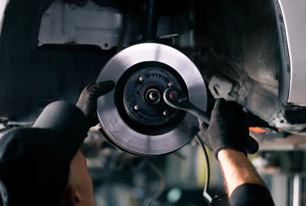 Customer vehicle lifted for brake service at Michael and Sons