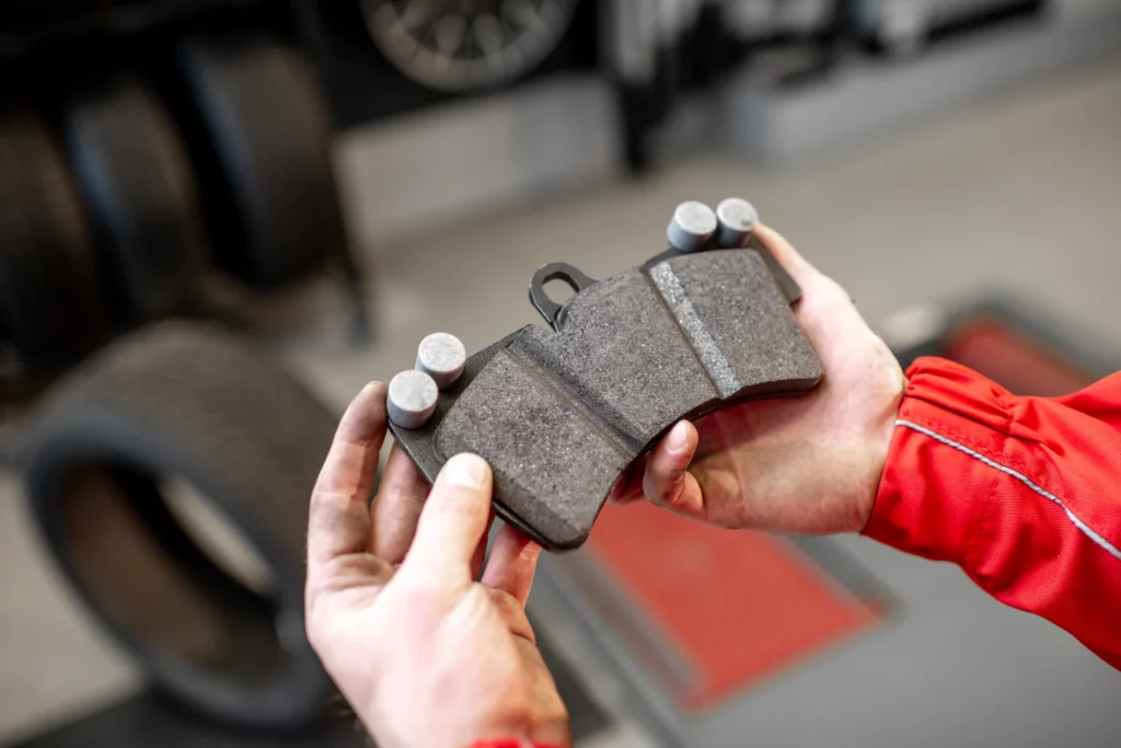 Mechanic changing brake pads in Tallaght garage